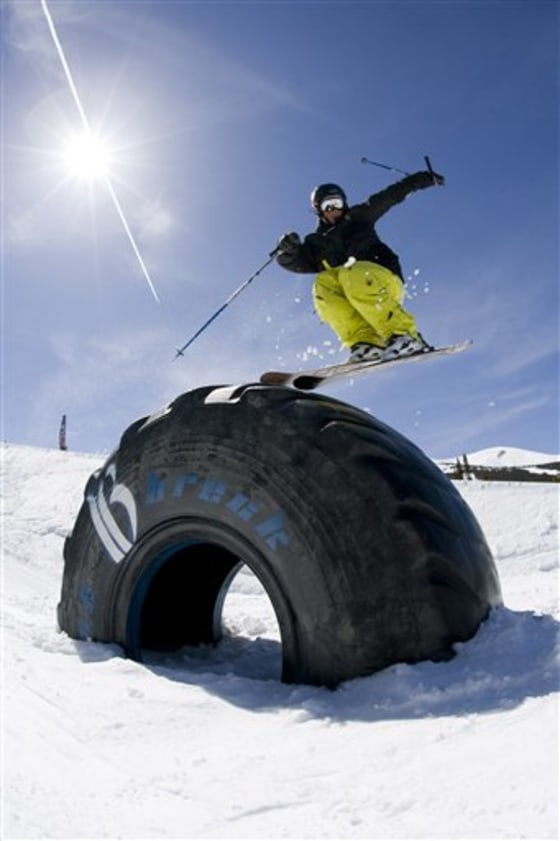 This undated photo courtesy of Aaron Dodds/Breckenridge Ski Resort shows a skier going over a truck tire at Breckenridge Ski Resort in Breckenridge, Colo.